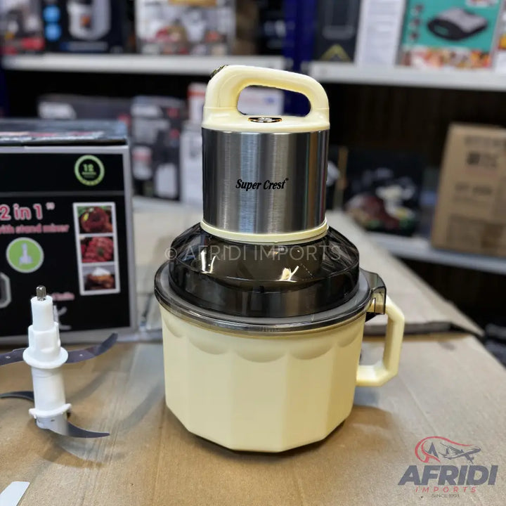 A cream-colored food chopper with a stainless steel motor unit and a black lid.