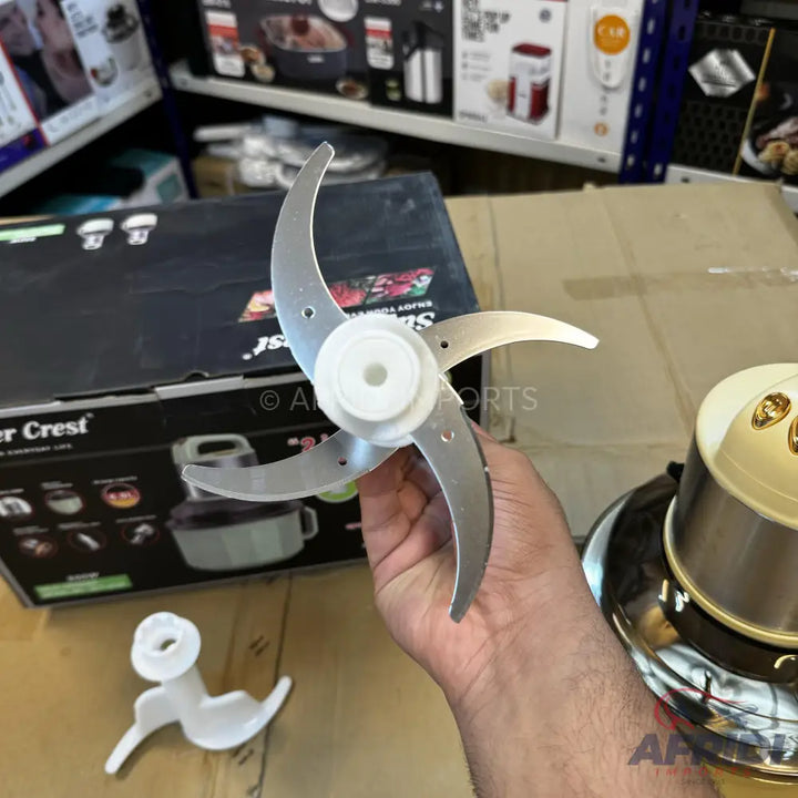 A four-blade food processor attachment with a white plastic hub.