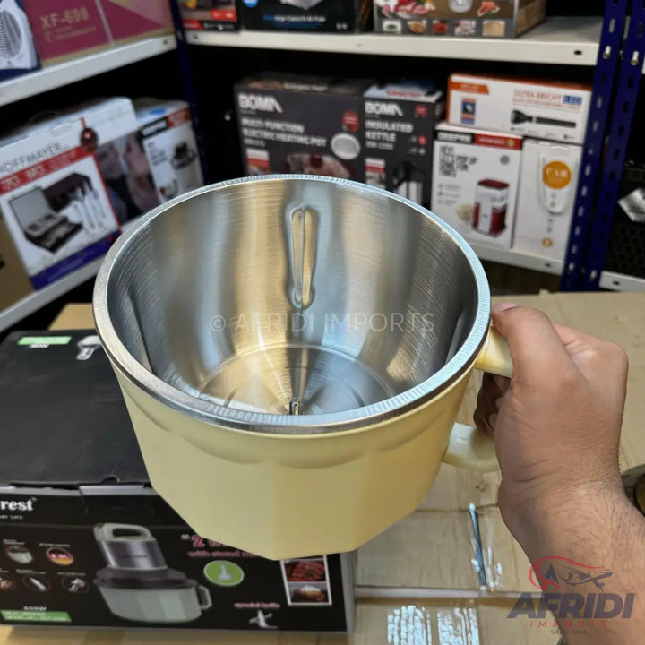 A cream-colored electric heating pot with a stainless steel interior and a handle.