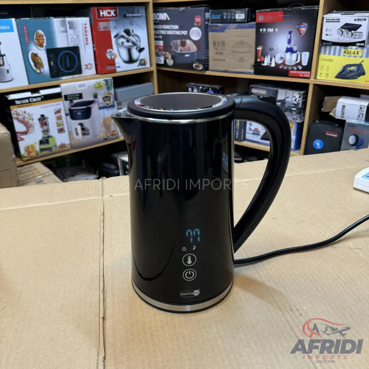 Black electric kettle with temperature control and digital display.