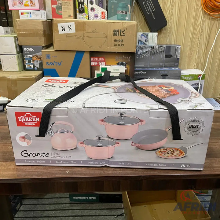 Pink 14-piece granite cookware set with a kettle, pots, and frying pans.