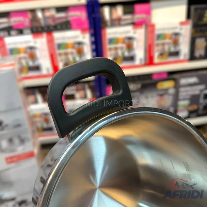 A stainless steel cooking pot with a black handle.