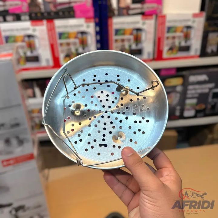 A collapsible metal vegetable steamer basket with a perforated bottom.
