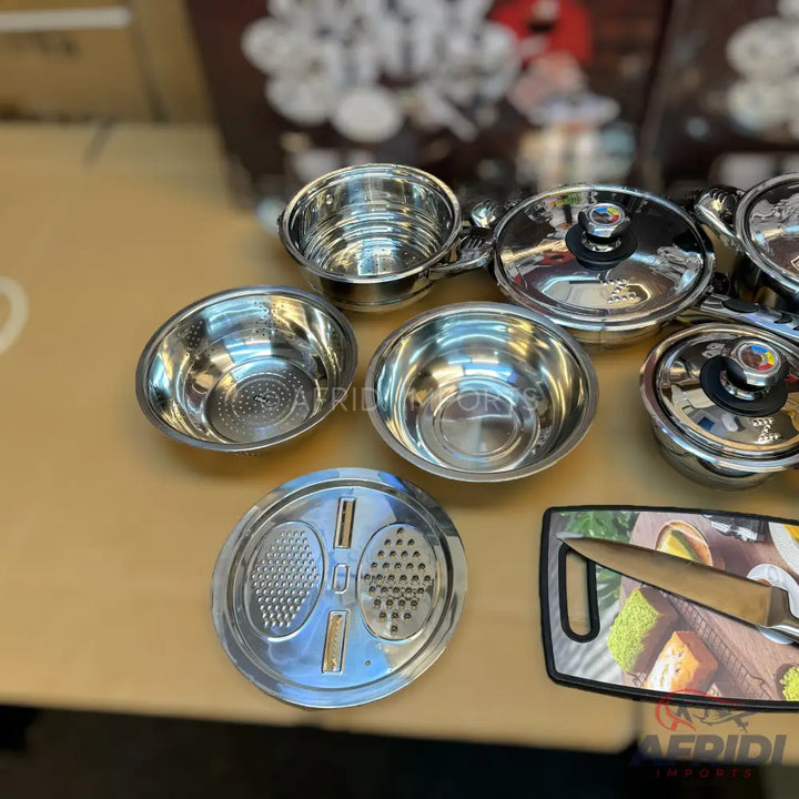 Stainless steel cookware set with accessories.