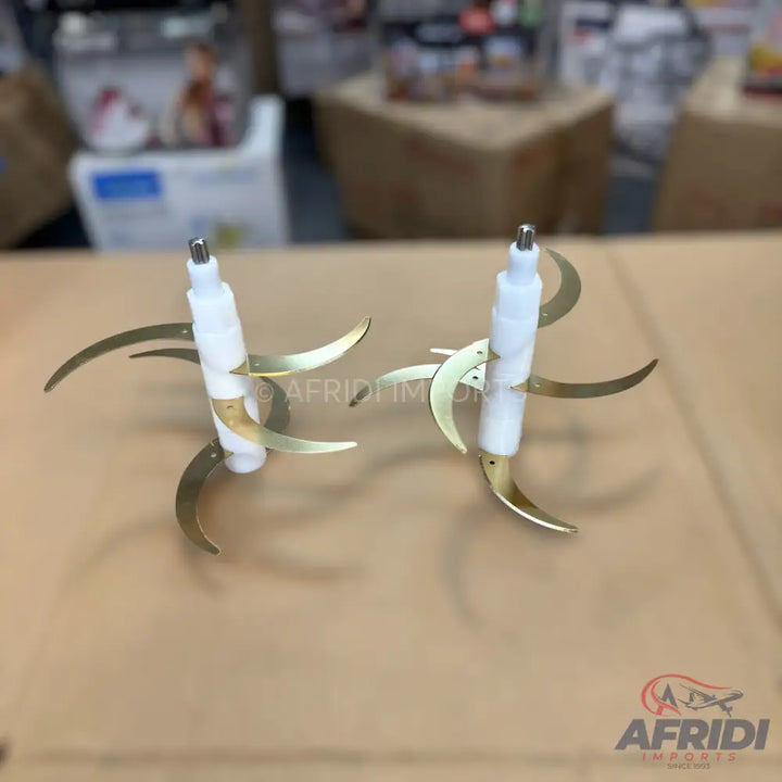 Two multi-bladed food processor attachments with gold-colored blades.
