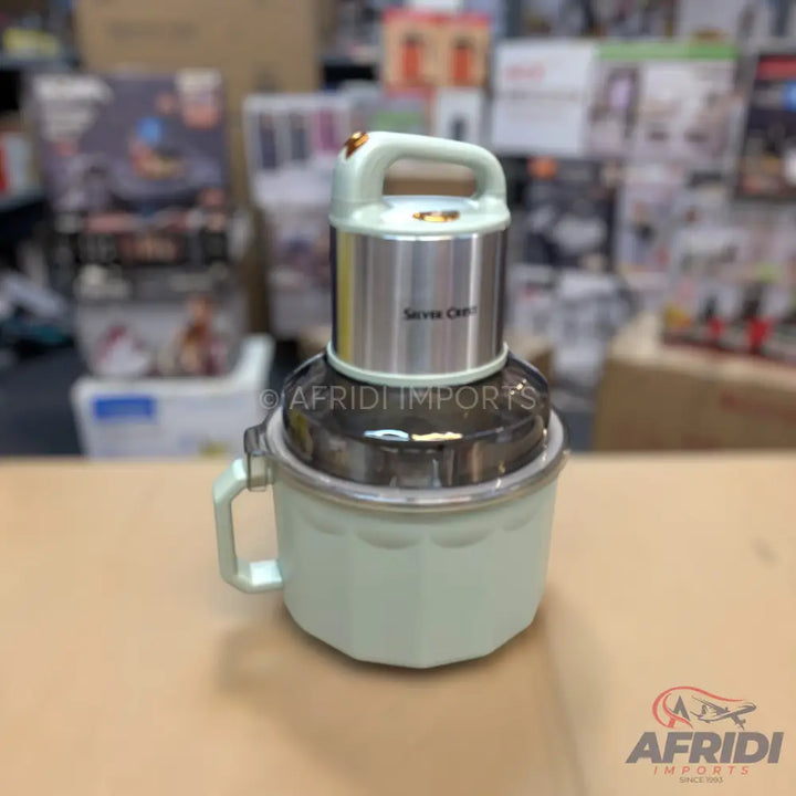 Light green and silver food processor with a handle.