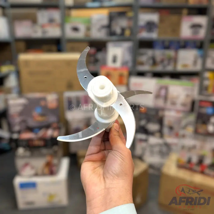 A four-blade food processor attachment with a white plastic hub.