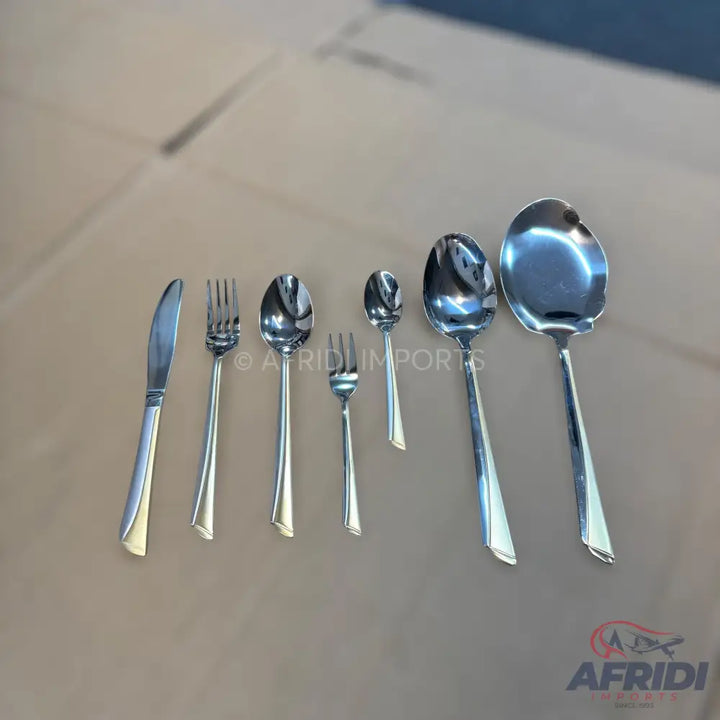 A complete set of shiny, silver-colored metal flatware with subtly detailed handles.