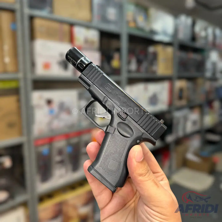 Black miniature replica pistol with a threaded barrel.