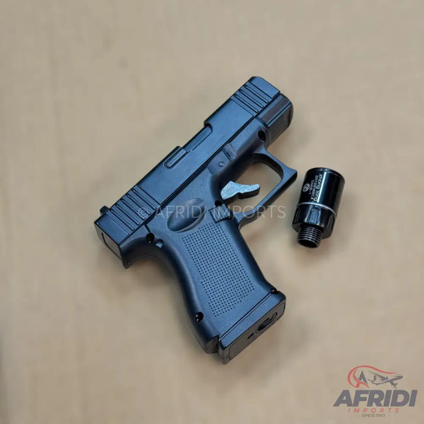 Black semi-automatic pistol with a textured grip and a separate threaded barrel attachment.