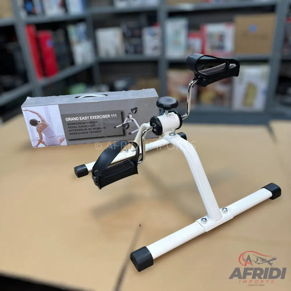 White and black mini pedal exerciser with adjustable resistance.