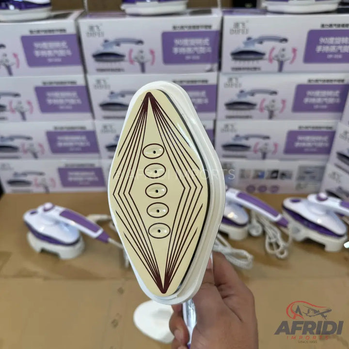 A handheld garment steamer with a purple handle and a cream-colored soleplate featuring a diamond pattern and six steam holes.