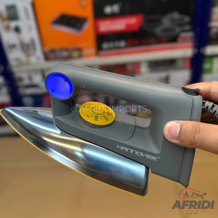 A grey and silver steam iron with a blue indicator light and yellow temperature dial.