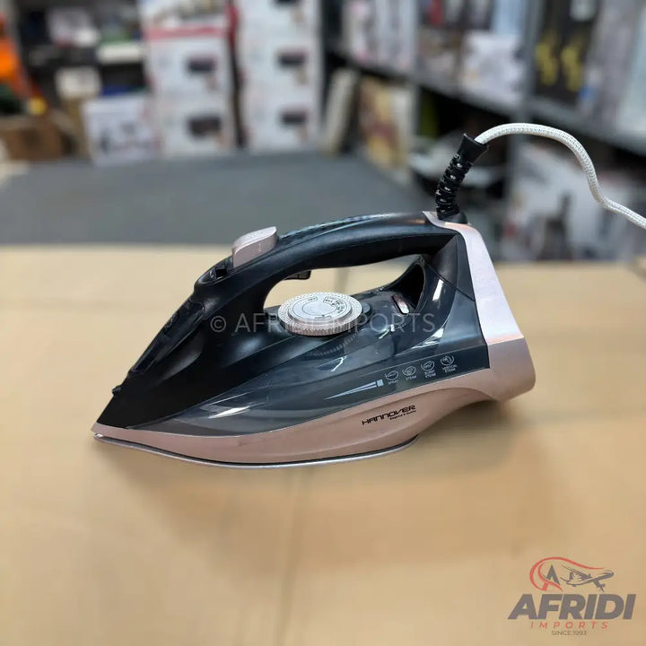 A black and rose gold steam iron with a white power cord.
