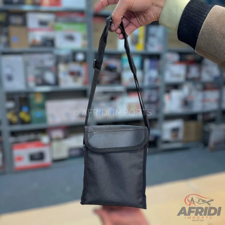 Black fabric shoulder bag with a top flap closure.