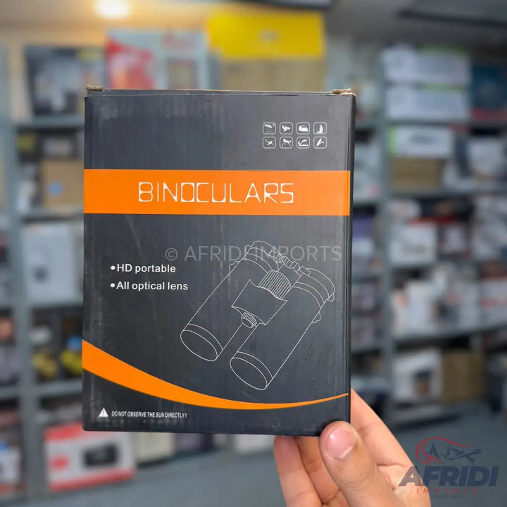 A boxed pair of binoculars with features like HD portability and all optical lenses.