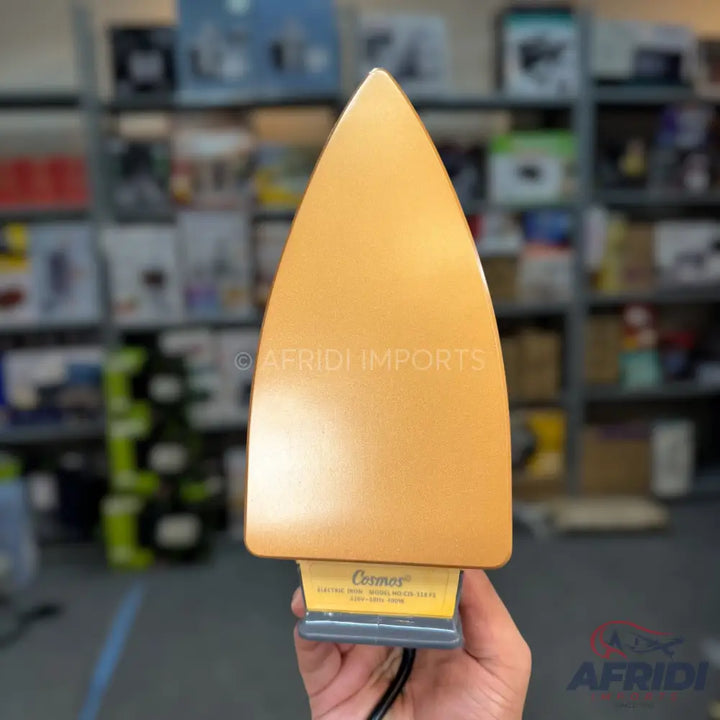 Shiny gold-colored dry iron with a black power cord.