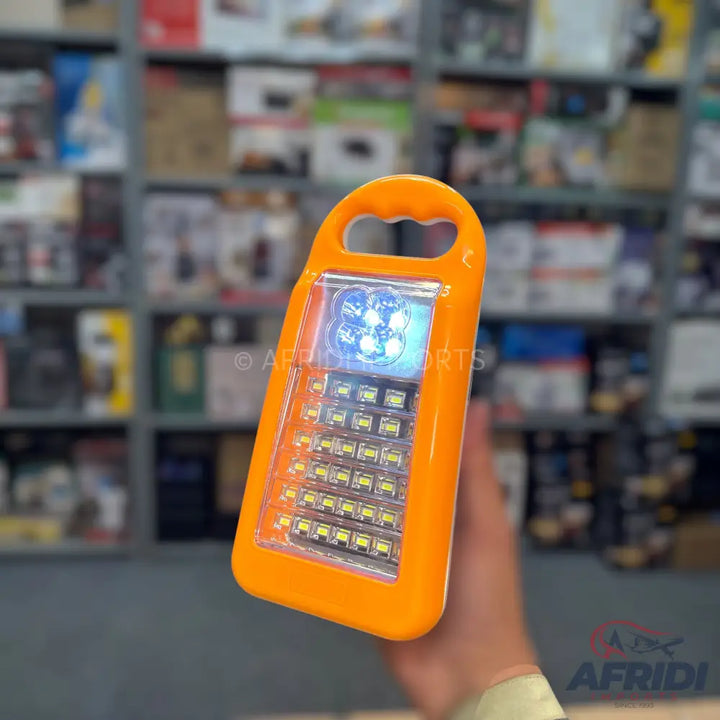 An orange portable lantern with multiple LED lights.
