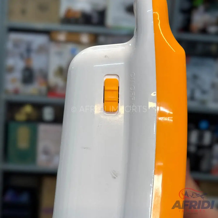 A white and orange plastic kitchen utensil with an orange slider switch.