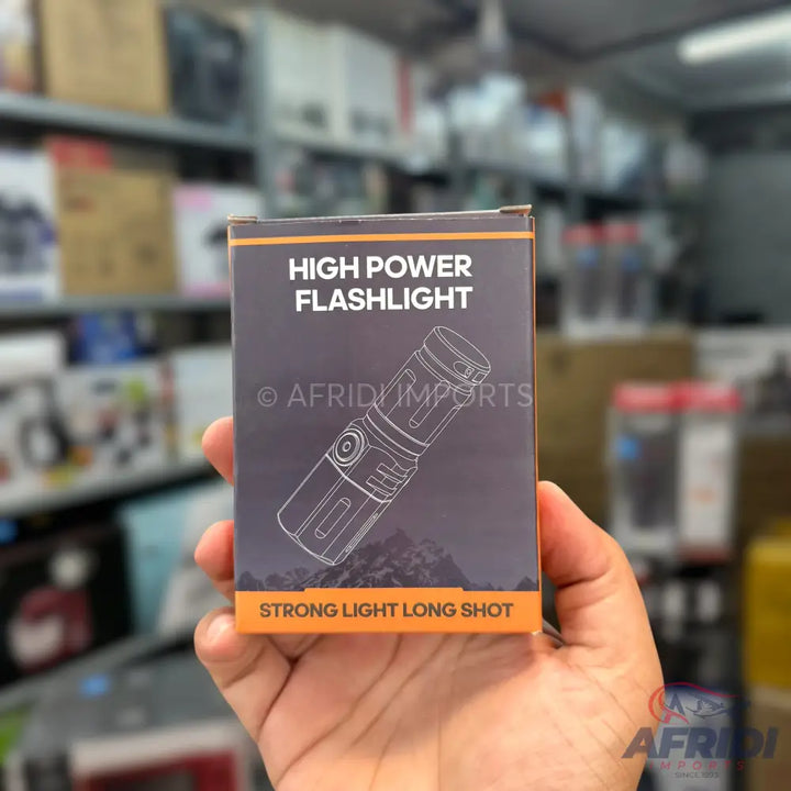 A high-power flashlight in its retail packaging.