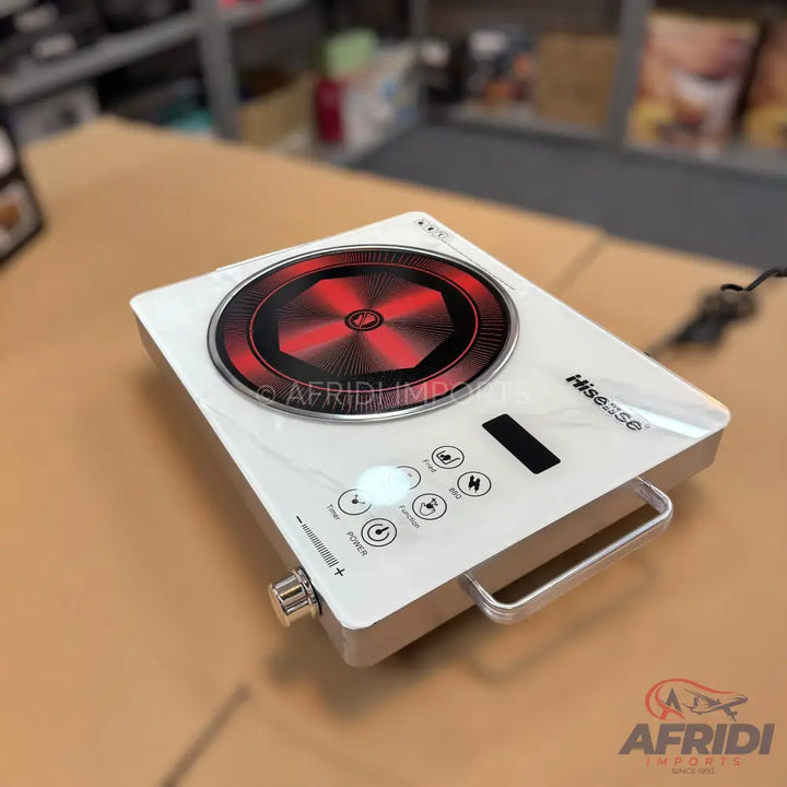 White portable induction cooktop with a red and black heating surface and silver handle.