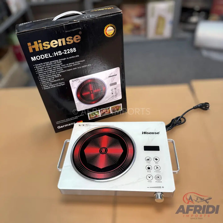 A white electric induction cooktop with a black and red heating element.