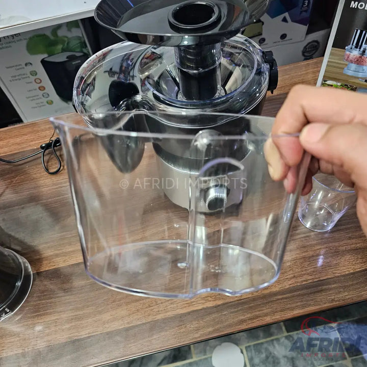 Clear plastic juice collection pitcher for a juicer.