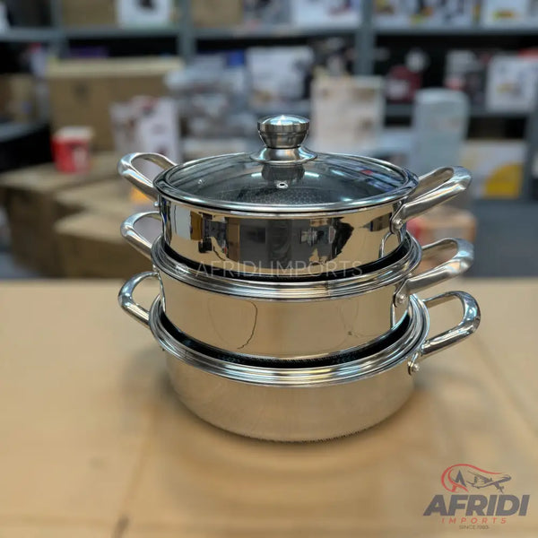 A three-tiered stainless steel food steamer with a glass lid.