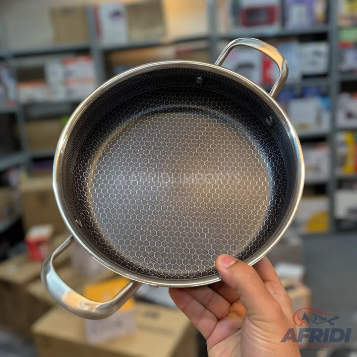 Stainless steel cooking pot with a honeycomb-patterned non-stick interior.