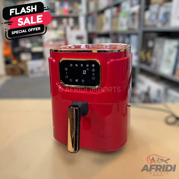 Red electric air fryer with a golden handle and a digital display.