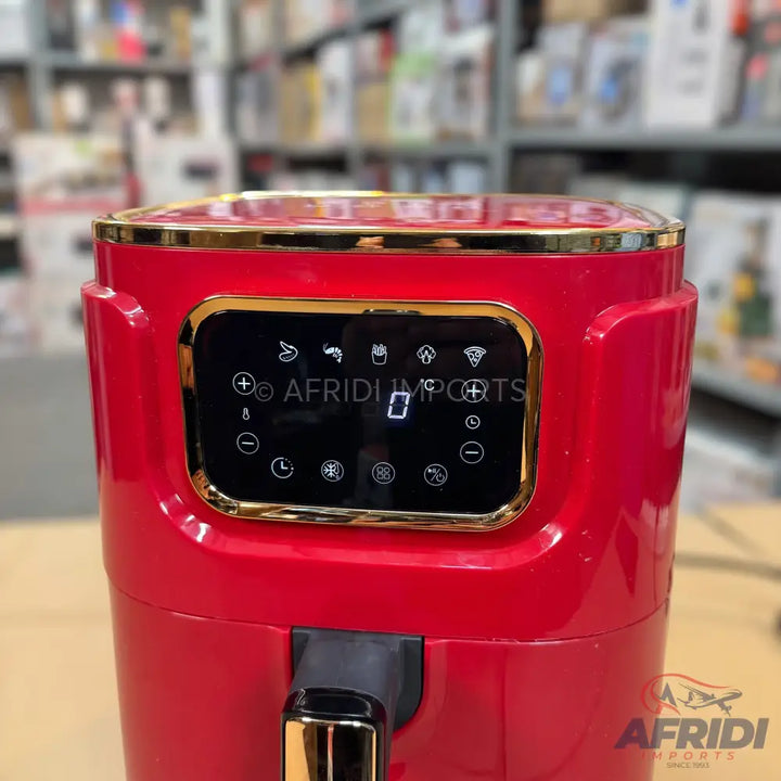 Red air fryer with a gold-trimmed digital touchscreen display.
