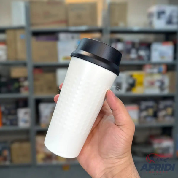 White travel mug with a black lid.
