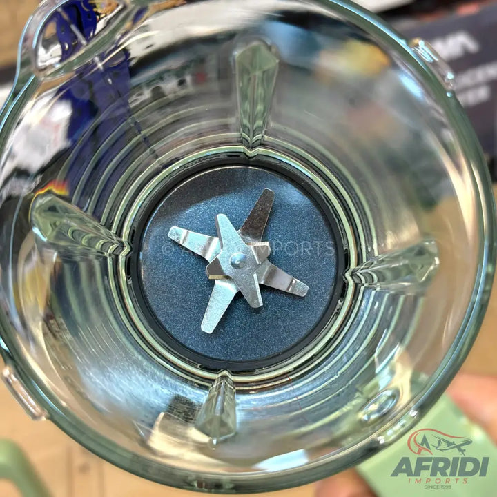 Blender jar with a four-pronged stainless steel blade assembly.