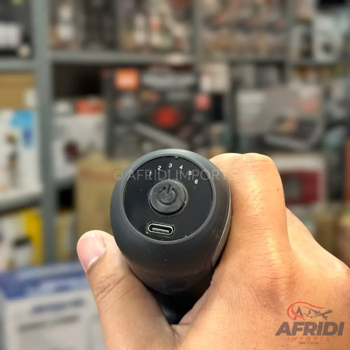 Black handheld massager with six speed settings and a USB-C charging port.