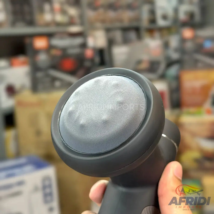 A dark gray handheld massage gun with a textured, round head.