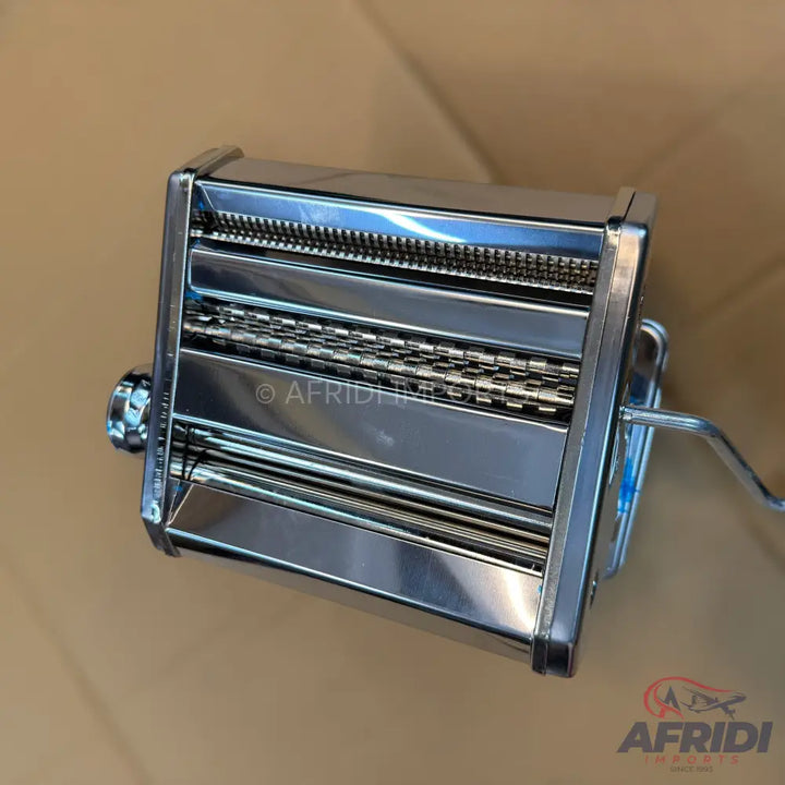 Stainless steel manual pasta maker with a hand crank.