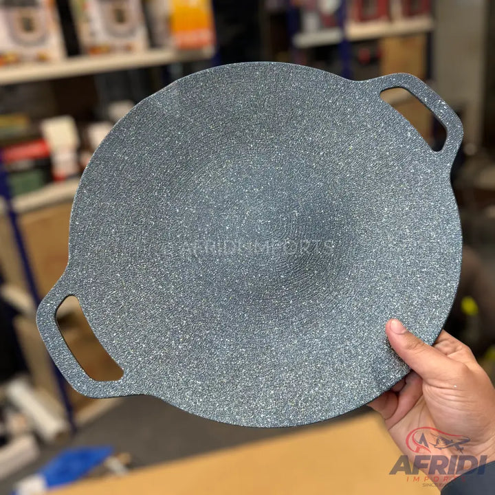 Round, speckled gray non-stick flat griddle with two integrated handles.