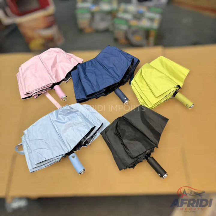 Five folded umbrellas in various colors.