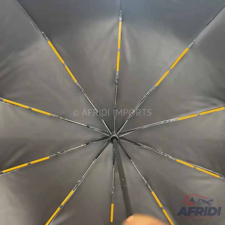 Black umbrella interior with yellow-accented ribs