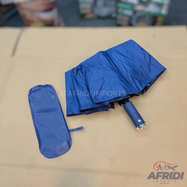 Folded blue umbrella with a matching storage sleeve.