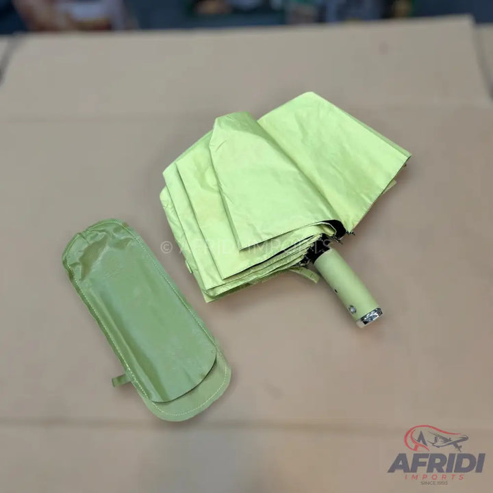 Pale green compact umbrella with a matching storage sleeve.
