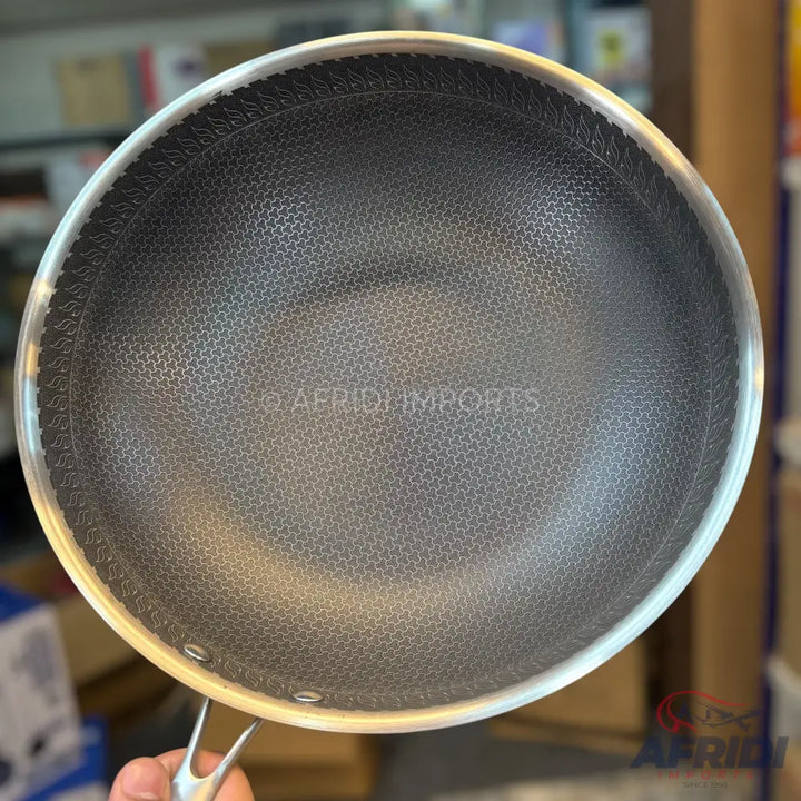 A non-stick frying pan with a textured honeycomb surface and a silver rim.