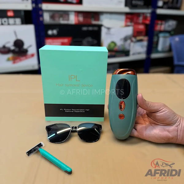 A boxed IPL hair removal device, accompanied by protective eyewear and a razor.