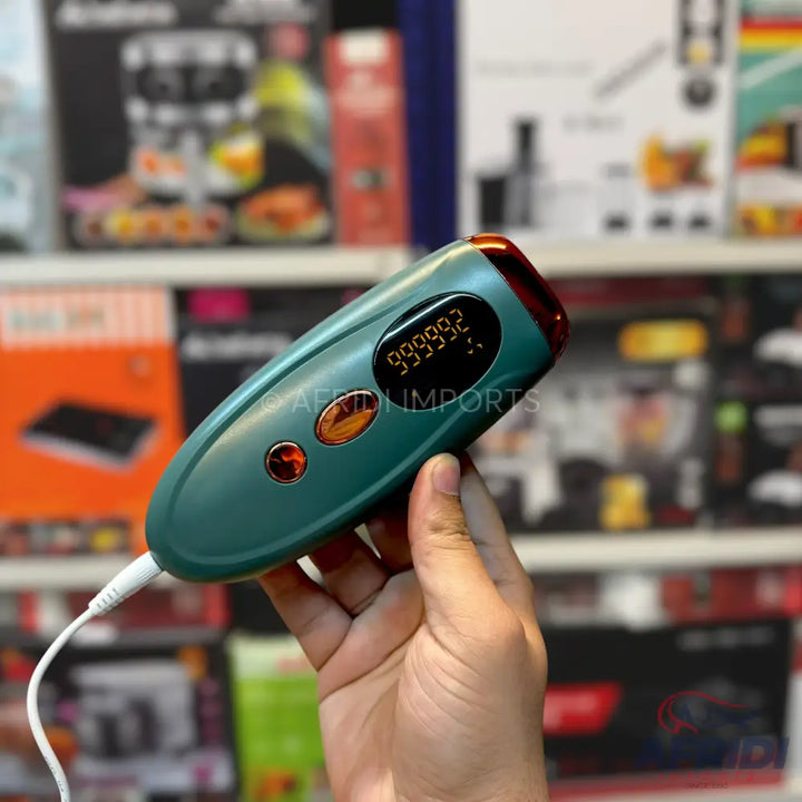 Handheld teal IPL hair removal device with a digital display.