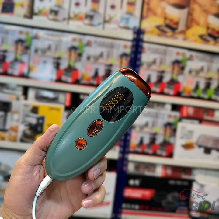 Handheld IPL hair removal device with a digital display.
