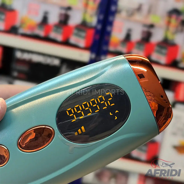 A handheld hair removal device with a digital display showing ’999992’’ and an intensity indicator.