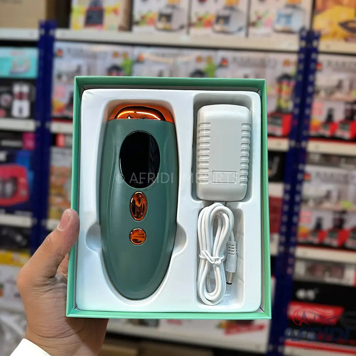 Teal and rose gold hair removal device with a power adapter and charging cable in a light green box.