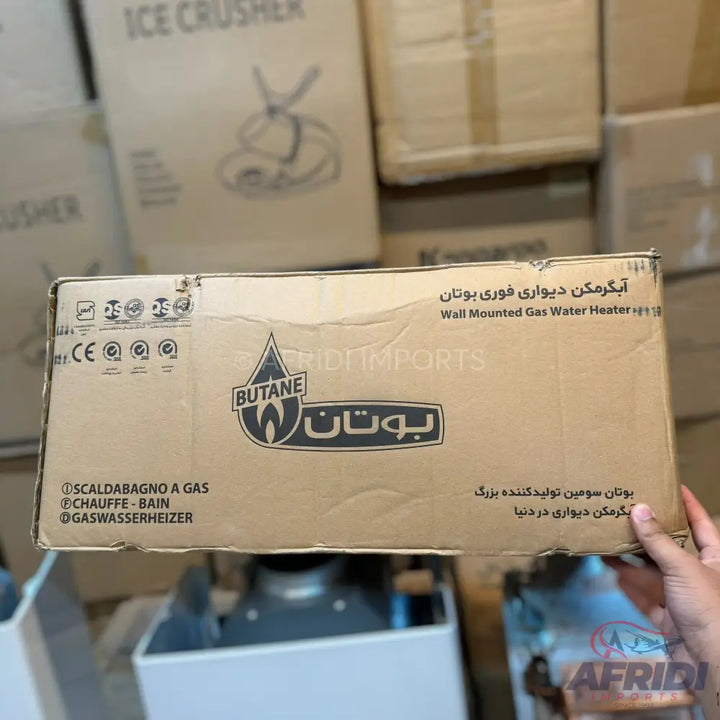 Butane wall-mounted gas water heater in a cardboard box.