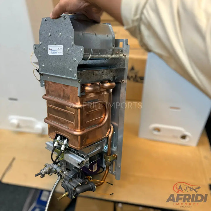 Internal components of a gas water heater, including a copper heat exchanger and a gas valve assembly.