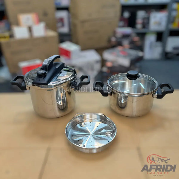 A set of stainless steel cookware, including a pressure cooker, a pot with a glass lid, and a steamer basket.